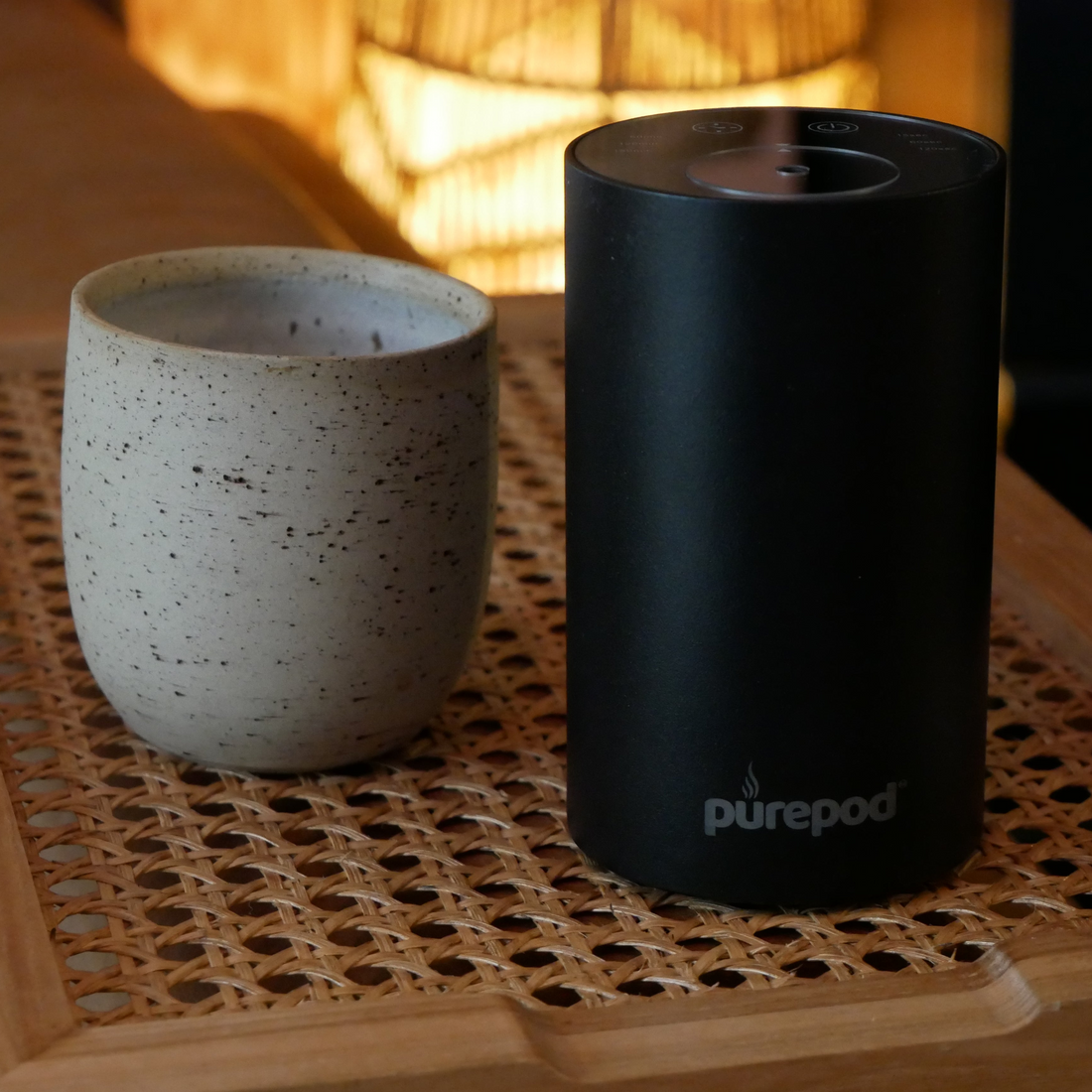Onyx Black PurePod diffuser beside a ceramic cup